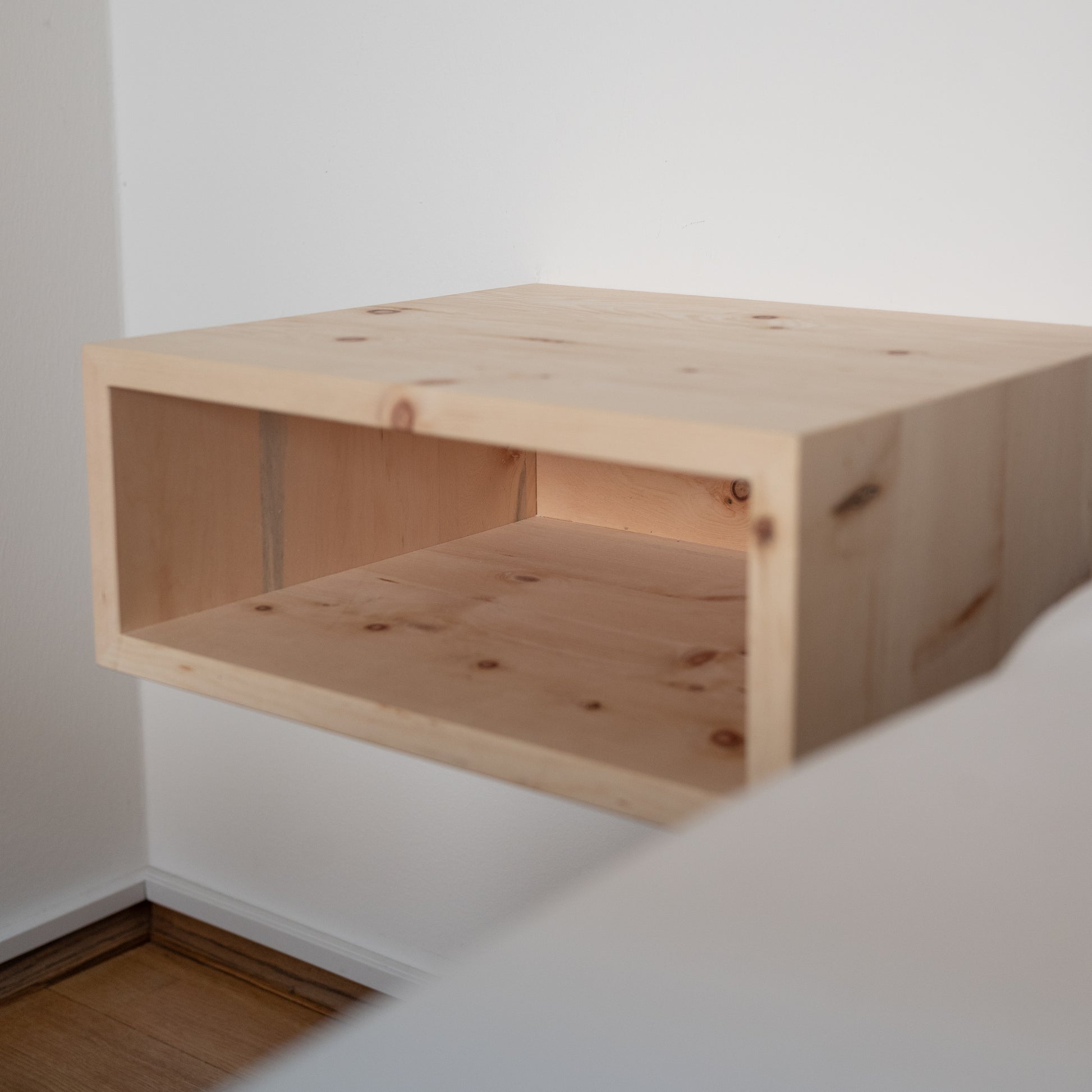 Minimalistisches Schlafzimmer mit schwebendem Nachttisch aus Zirbenholz